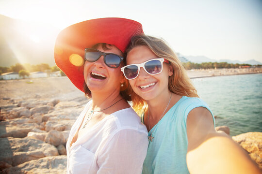 Happy people, Mother And Adult Daughter Making Selfe On The Beach Traveling Together