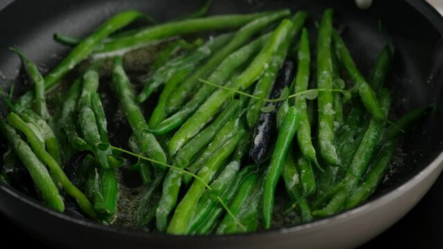 Green beans with spices ready for cooking in frying pan. Bio green beans. Cooking healthy home-made food.