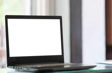 Fototapeta premium Computer on wood table and white screen for text