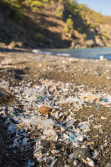 Small plastic parts and microplastics on the sand beach