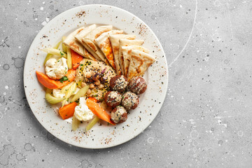 Falafel balls with hummus, tabouleh salad and pita. Close up.