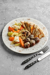 Falafel balls with hummus, tabouleh salad and pita. Close up.