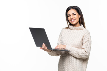 Young smiling woman using laptop computer and looking camera isolated over white