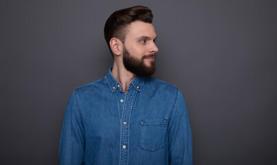 Photo of side view close up portrait of the handsome stylish bearded hipster man after barber shop or salon