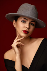 portrait of fashionable beautiful girl on red bakground.