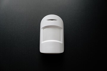 The motion sensor on the black wall. device that tracks the movement of objects. It is used to...