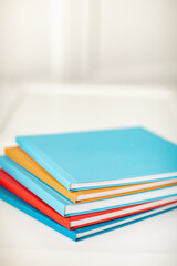 pyramid of multicolored books or photo albums. Place for the inscription. selling photographer's services or printing.