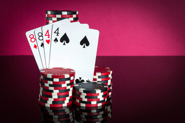 Obraz premium Poker cards with two pairs combination. Close-up of playing cards and chips in poker club. Free advertising space