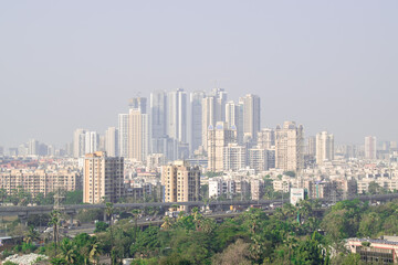 Obraz premium Rural to urban development of mumbai with trees and skyscrapers in background