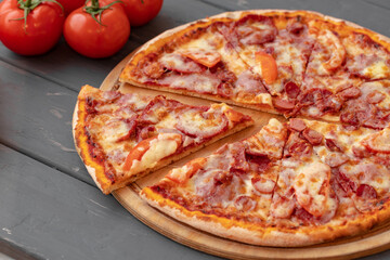 Close up of freshly baked pizza on black wooden table