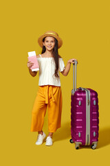 Happy little child girl in hat with pink suitcase