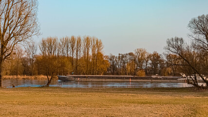 Beautiful sunny winter view with a cargo ship near Aicha, Danube, Bavaria, Germany