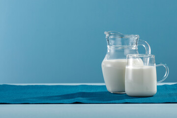 Fresh milk for breakfast in the sunshine on a blue background 
