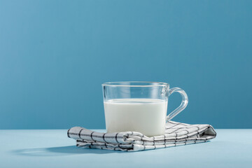 Fresh milk for breakfast in the sunshine on a blue background 