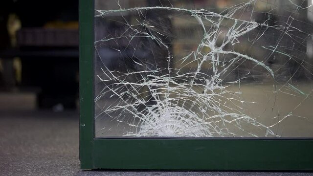 Damaged store entrance broken glass vandalism