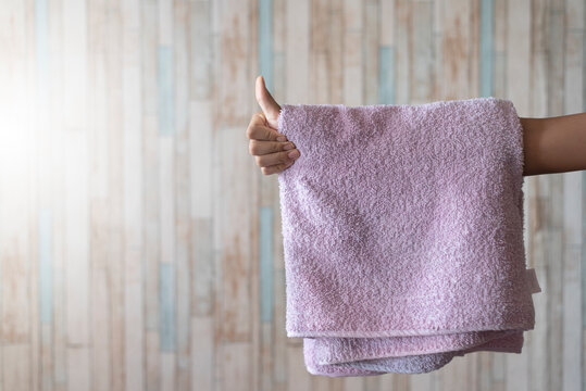 Man showing thumb up with towel hanging on his hand