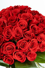 Bouquet of red roses with orange bow.