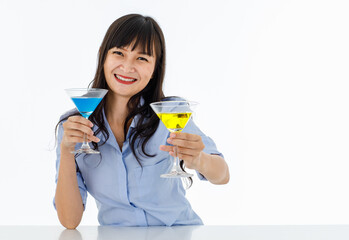 Asia young woman long black hair beautiful smile clinking eyes wear shirt look at camera. Hands holding cocktail glass one blue other yellow color. Shooting in studio with white background.