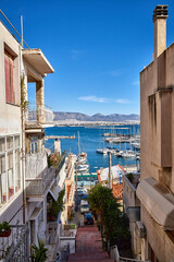 A narrow street in Athens with view to Piraeus Port and the Aegean Sea, Greece