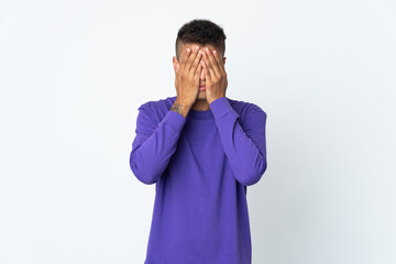 Young brazilian man isolated on white background covering eyes by hands