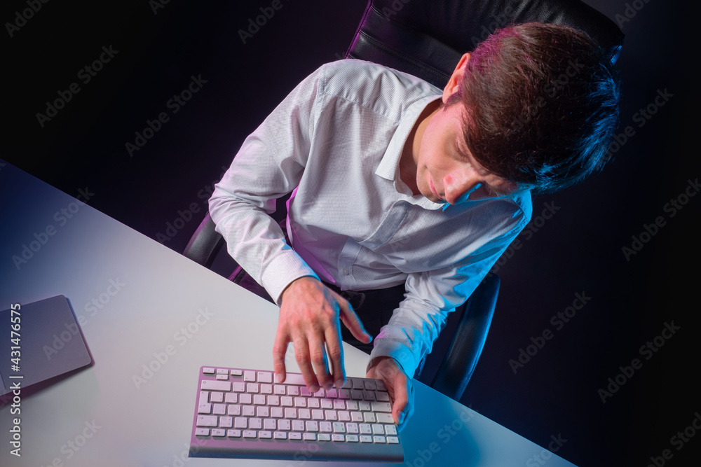 Poster a man is typing on a computer keyboard. top view of a man with a computer keyboard. a man sits in an