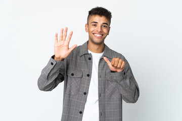 Young brazilian man isolated on white background counting six with fingers