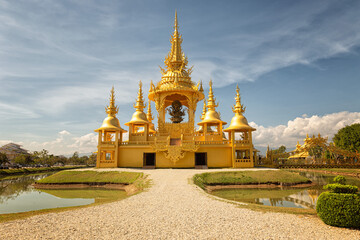 Naklejka premium Gold Yellow Temple, Wat Rong Khun Buddhist Complex - Chiang Rai Thailand