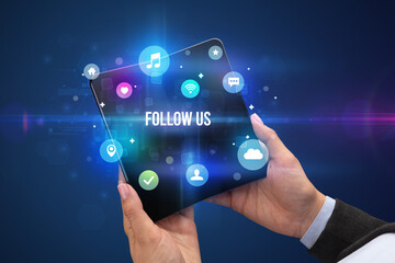 Businessman holding a foldable smartphone