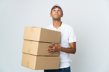 Delivery Brazilian man isolated on white background and looking up