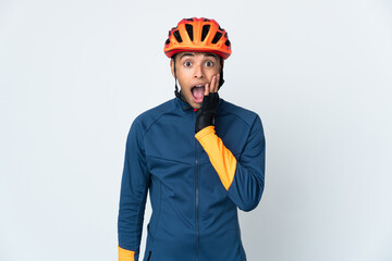 Young cyclist Brazilian man isolated on white background with surprise and shocked facial expression - obrazy, fototapety, plakaty