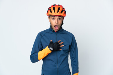 Young cyclist Brazilian man isolated on white background surprised and shocked while looking right - obrazy, fototapety, plakaty