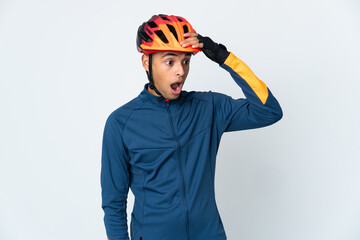 Young cyclist Brazilian man isolated on white background doing surprise gesture while looking to the side - obrazy, fototapety, plakaty