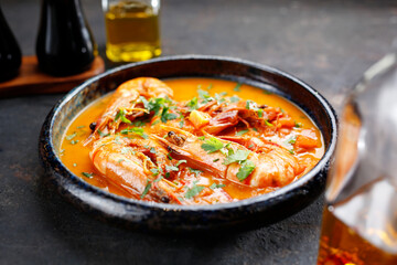 Shrimps in tomato sauce with curry. Tasty dishes. Serving proposal. Culinary photography.