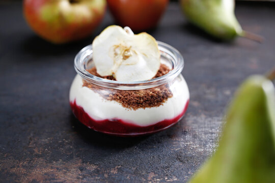 Dessert in a jar. Raspberry mousse with yoghurt cheesecake and chocolate crumble. Culinary photography.