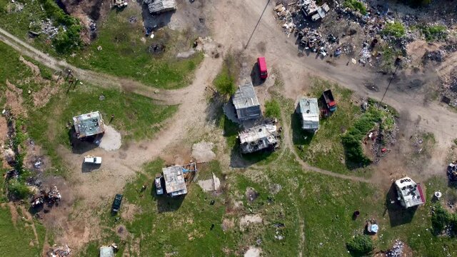 Aerial drone view of Romani people settlement. Small barracks. Roma communities living in poverty.