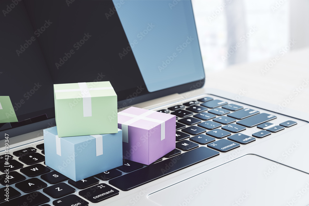 Poster courier service and delivery concept with colorful boxes on laptop keyboard