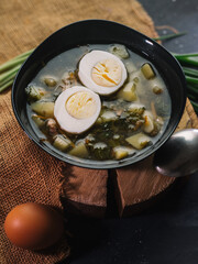 Russian traditional food, soup with sorrel, nettle, potatoes and egg