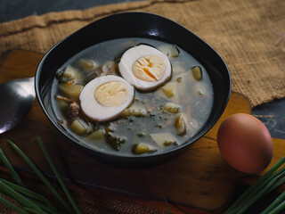 Russian traditional food, soup with sorrel, nettle, potatoes and egg