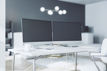 Black blank modern computer monitors on white table at home office with monochrome style interior. 3D rendering, mockup