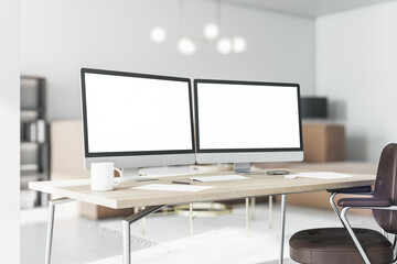 Blank white computer monitors on light wooden table with modern keyboard and coffee mug in stylish home office. 3D rendering, mockup