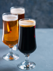 Three glasses of beer . Different beer styles, pilsner, lager, stout