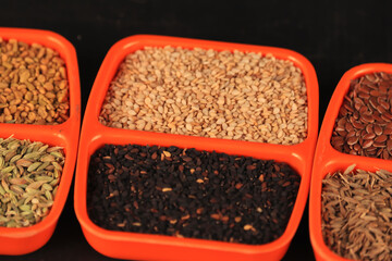 Black and white sesame seeds in plate,top view,black and white sesame in a orenge plate on agriculture background,HD footage of sesame seeds