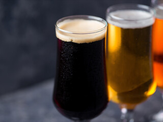 Three glasses of beer . Different beer styles, pilsner, lager, stout