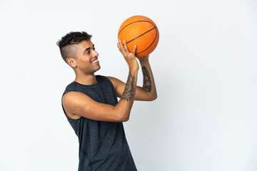 Young Brazilian man over isolated background playing basketball