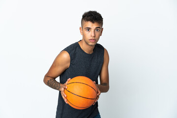 Obraz premium Young Brazilian man over isolated background playing basketball