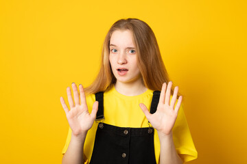 Keep away and leave me alone. Intense unhappy girl shows enough or stop gesture, expresses...