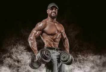 Foto op Plexiglas Muscular athlete posing in the studio with dumbbells. Fitness and classic bodybuilding concept. © andy_gin