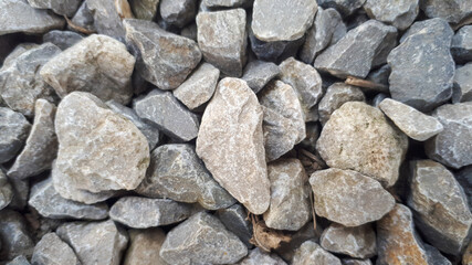 Gravel stones flooring pattern surface texture. Close-up of exterior material. Small road stone background, dark gravel pebbles stone