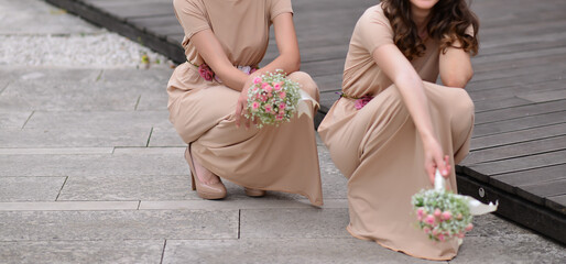 bridesmaids holding flower bouquets in their hands