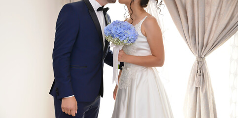 bride and groom together holding a blue flower bouquet